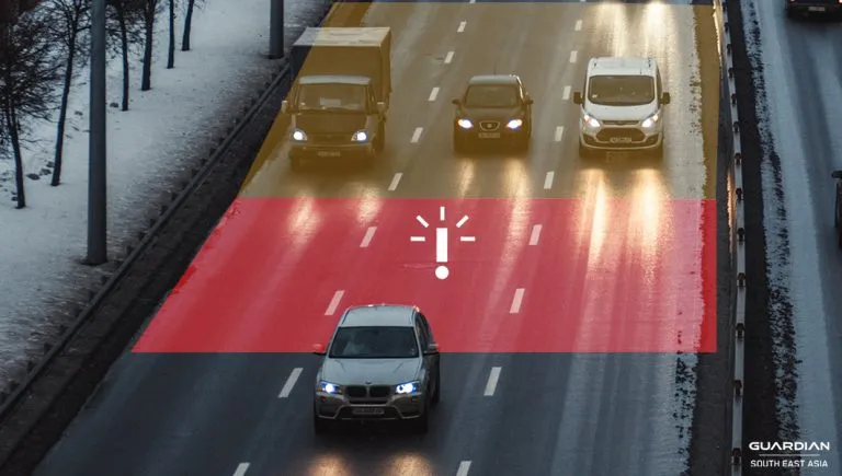 blind spot monitoring sensor car on road followed by three vehicles